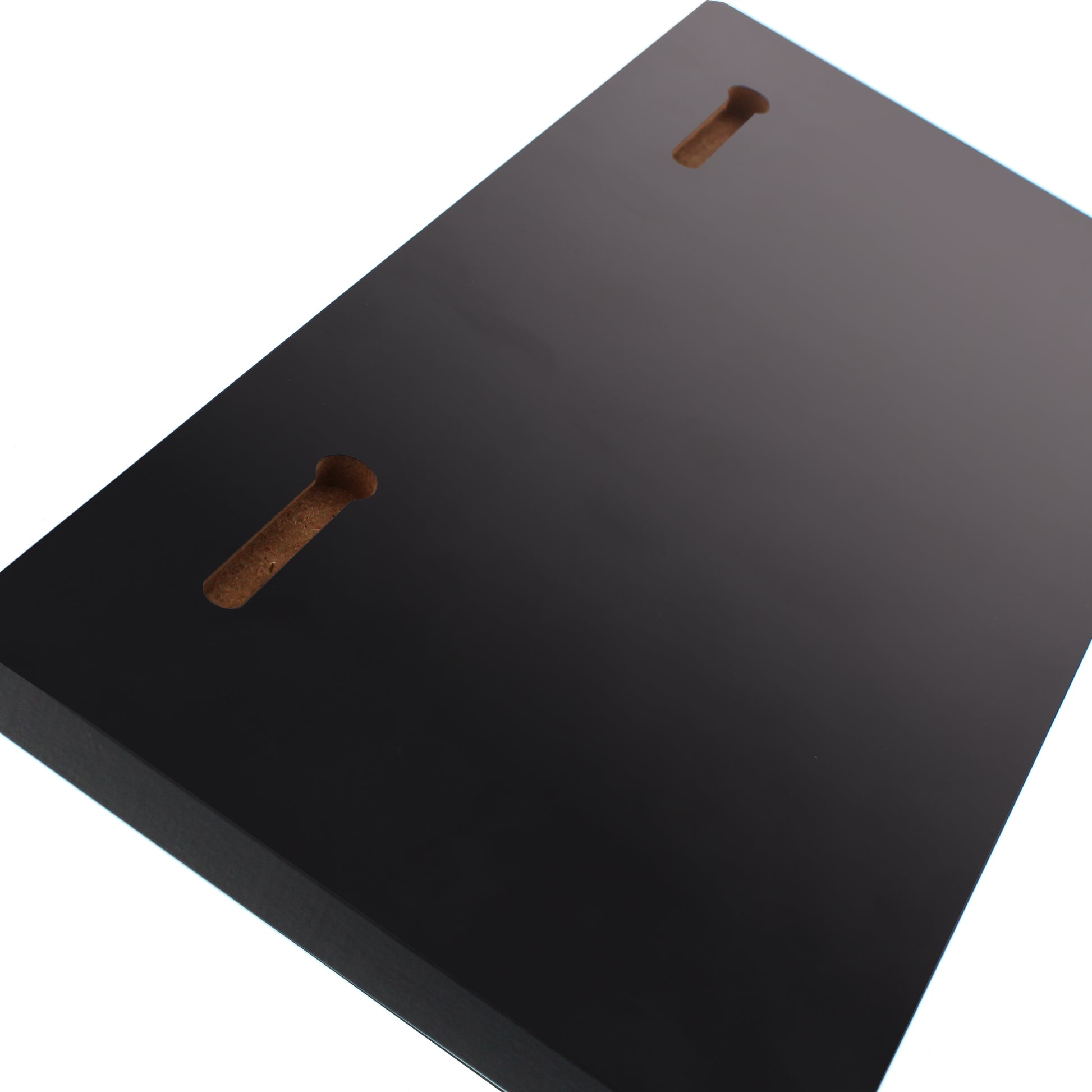 The back of the key holder. Black rectangular object with two brown slots on a white background