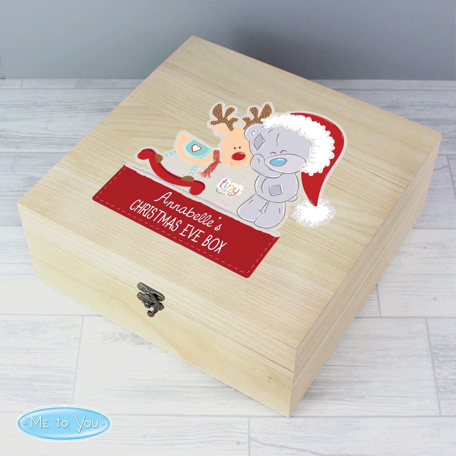 Wooden Christmas Eve box with cartoon characters and 'Me to You' branding on a light wooden floor.