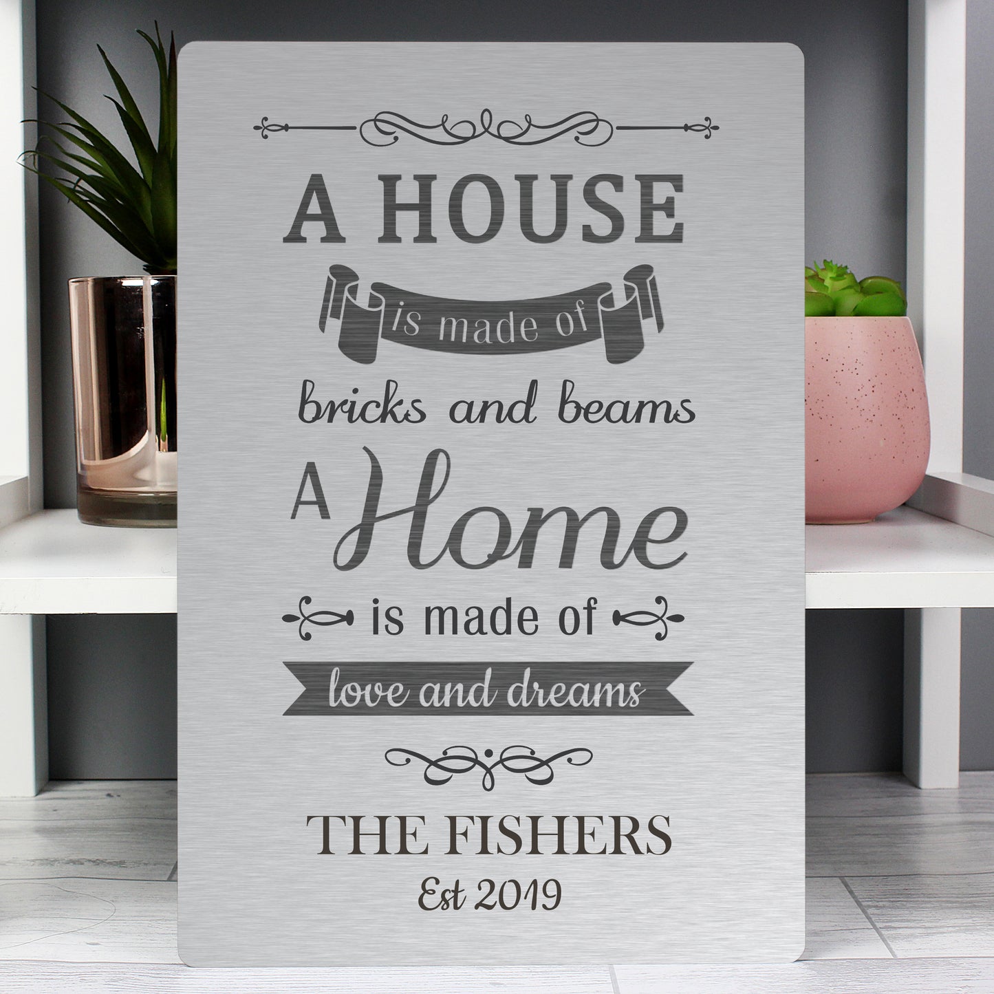 Personalised Decorative sign with a quote about home and family on a shelf.
