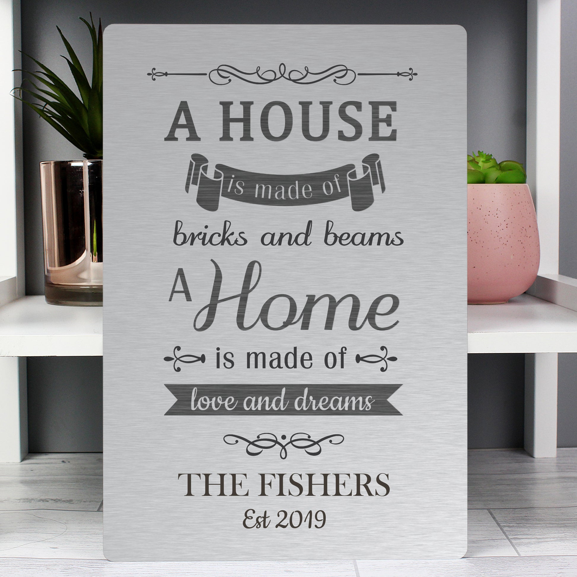 Personalised Decorative sign with a quote about home and family on a shelf.