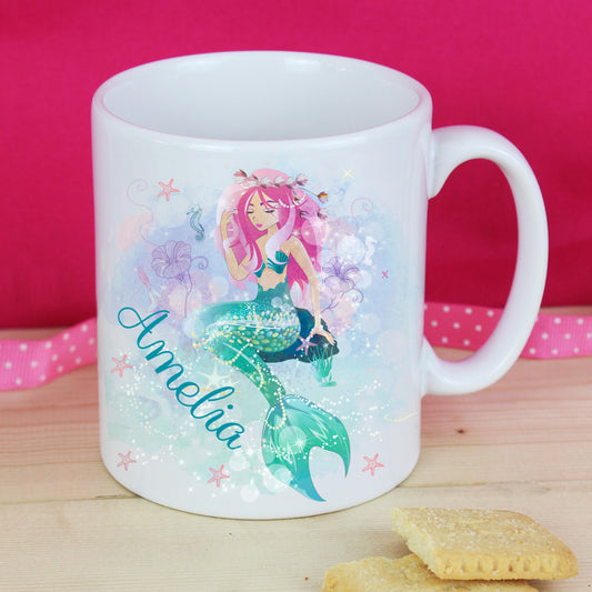 White mug with a mermaid design and the name 'Amelia' on a pink background