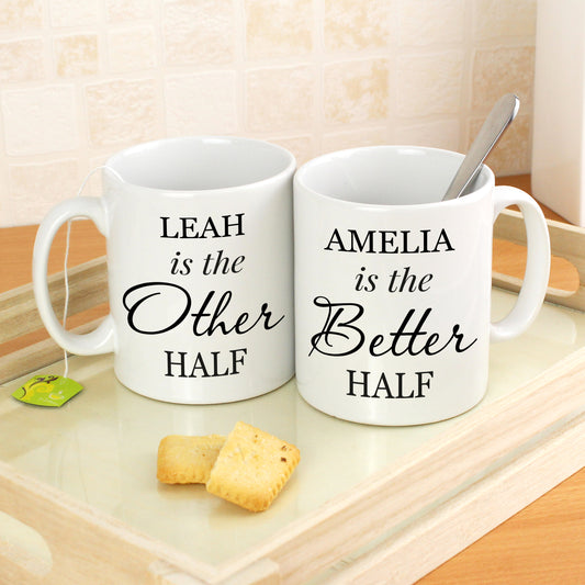 Two personalised white mugs with humorous text on a wooden surface.