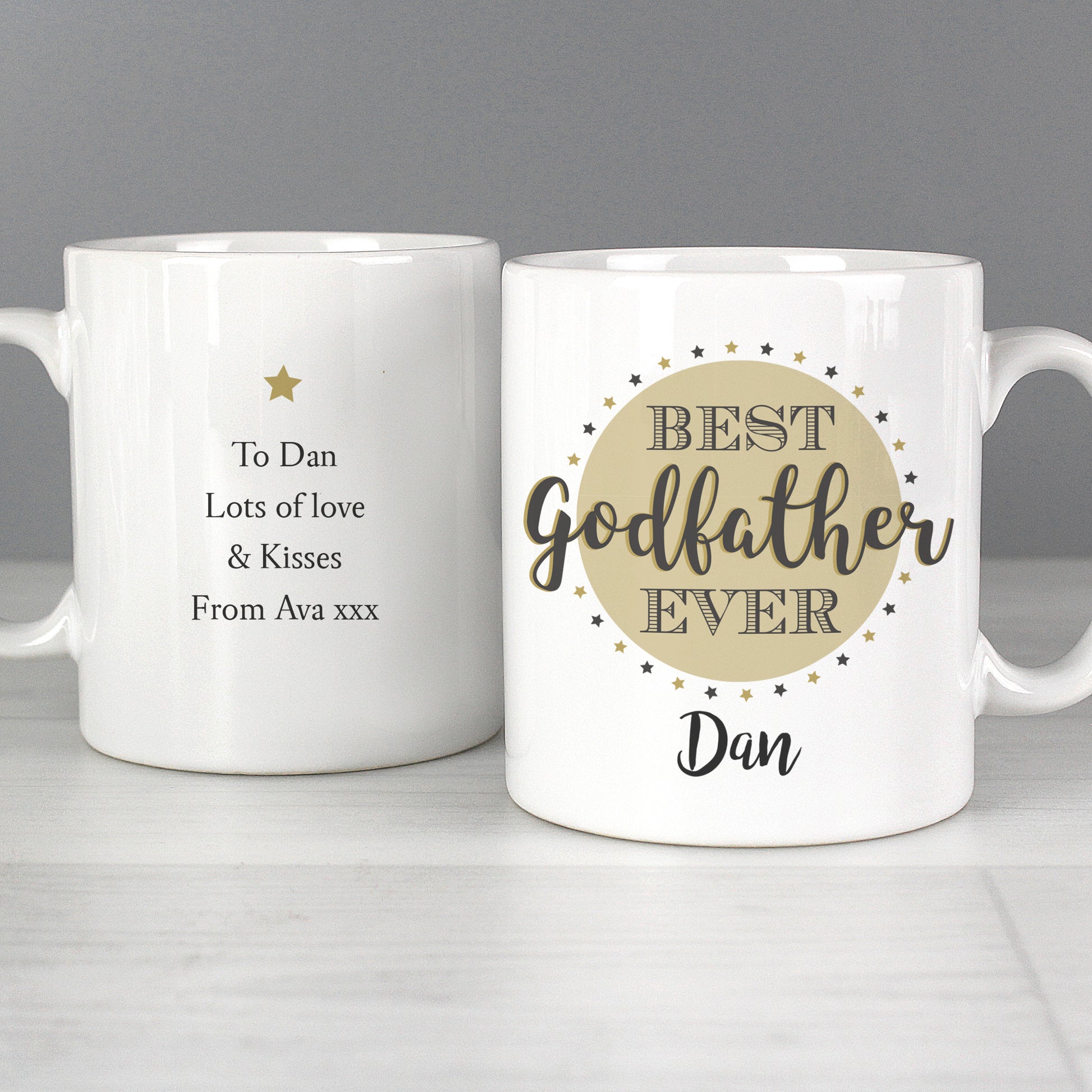 Two white mugs with personalised text on a grey background