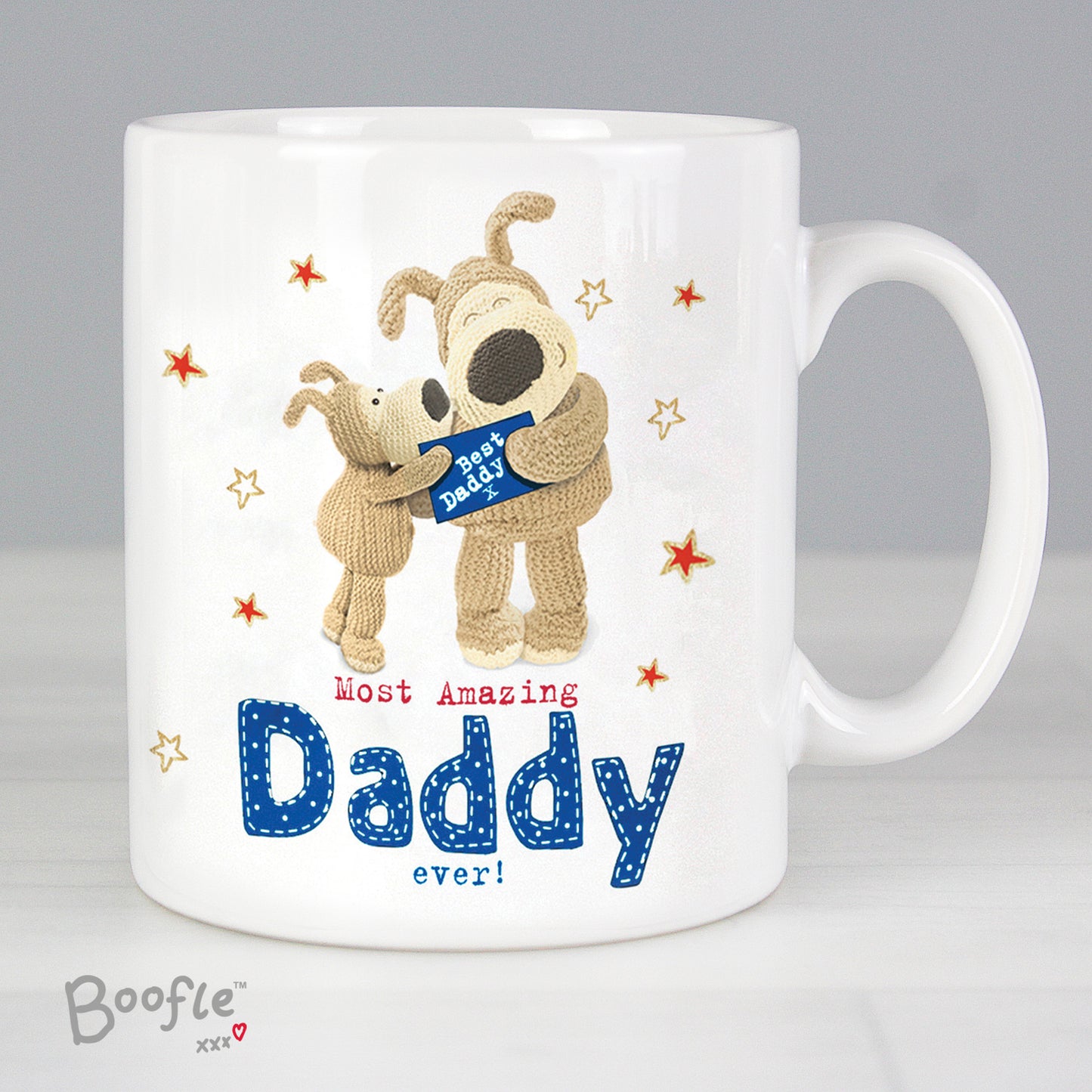 White mug with cartoon dogs holding a 'Best Dad' shirt, text 'Most Amazing Daddy ever!' and 'Boofle' branding.
