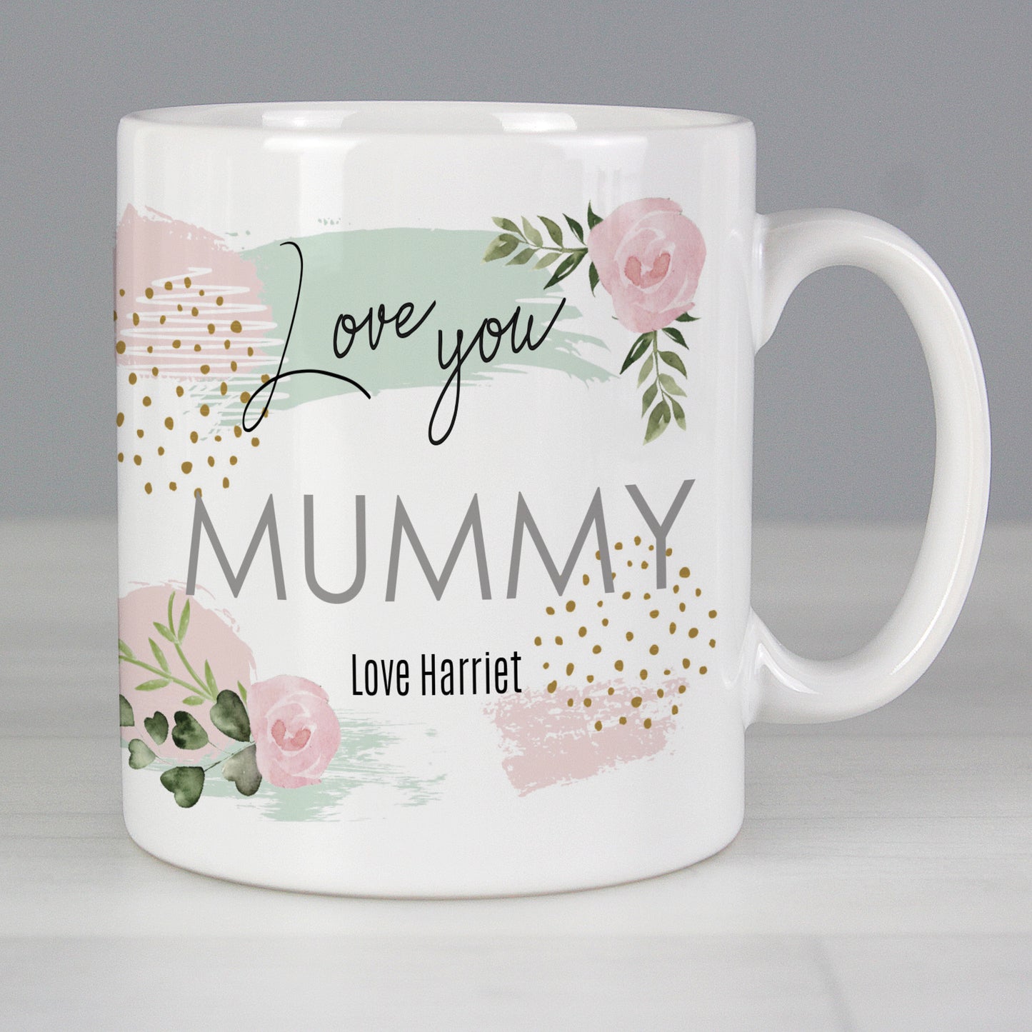 White mug with floral design and text 'Love you Mummy Love Harriet' on a grey background