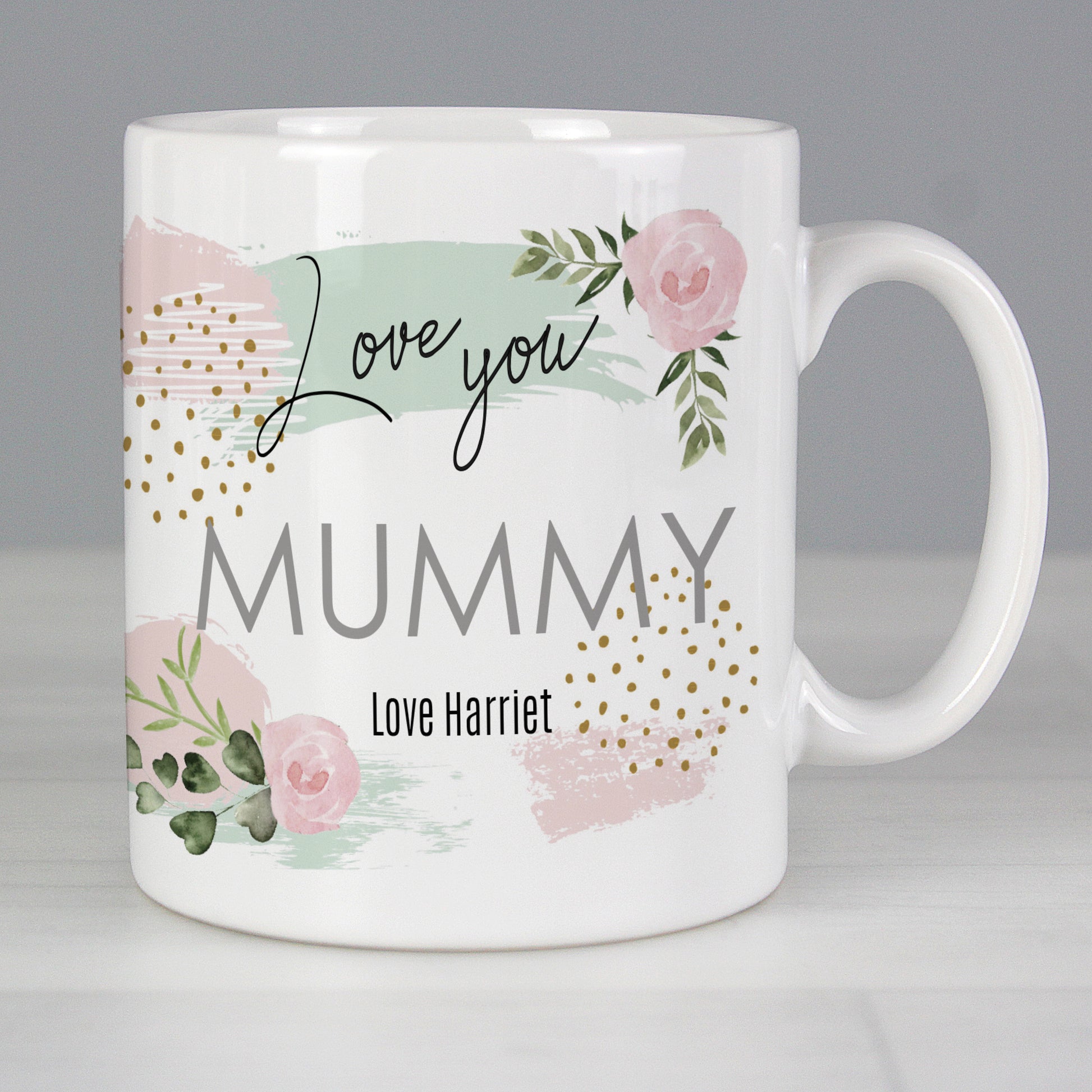 White mug with floral design and text 'Love you Mummy Love Harriet' on a grey background