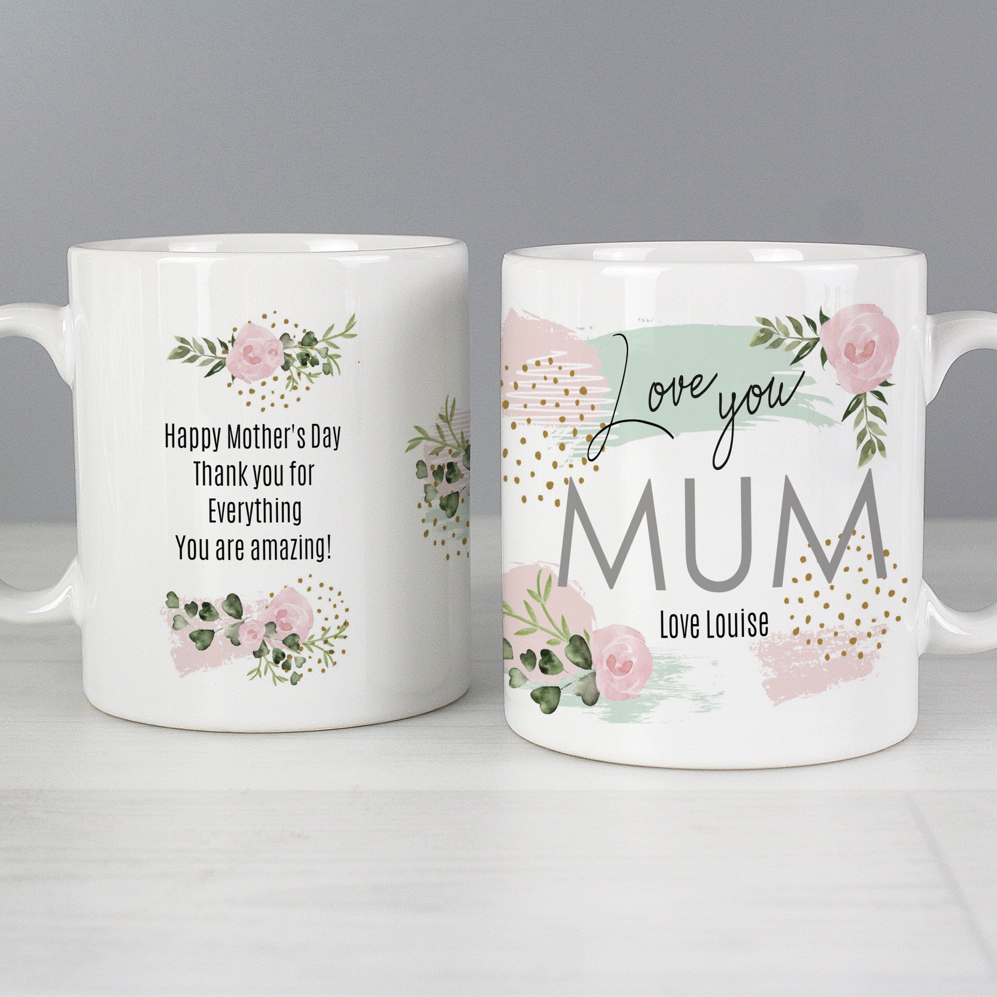 Two personalised white mugs with floral designs and Mother's Day messages on a grey background