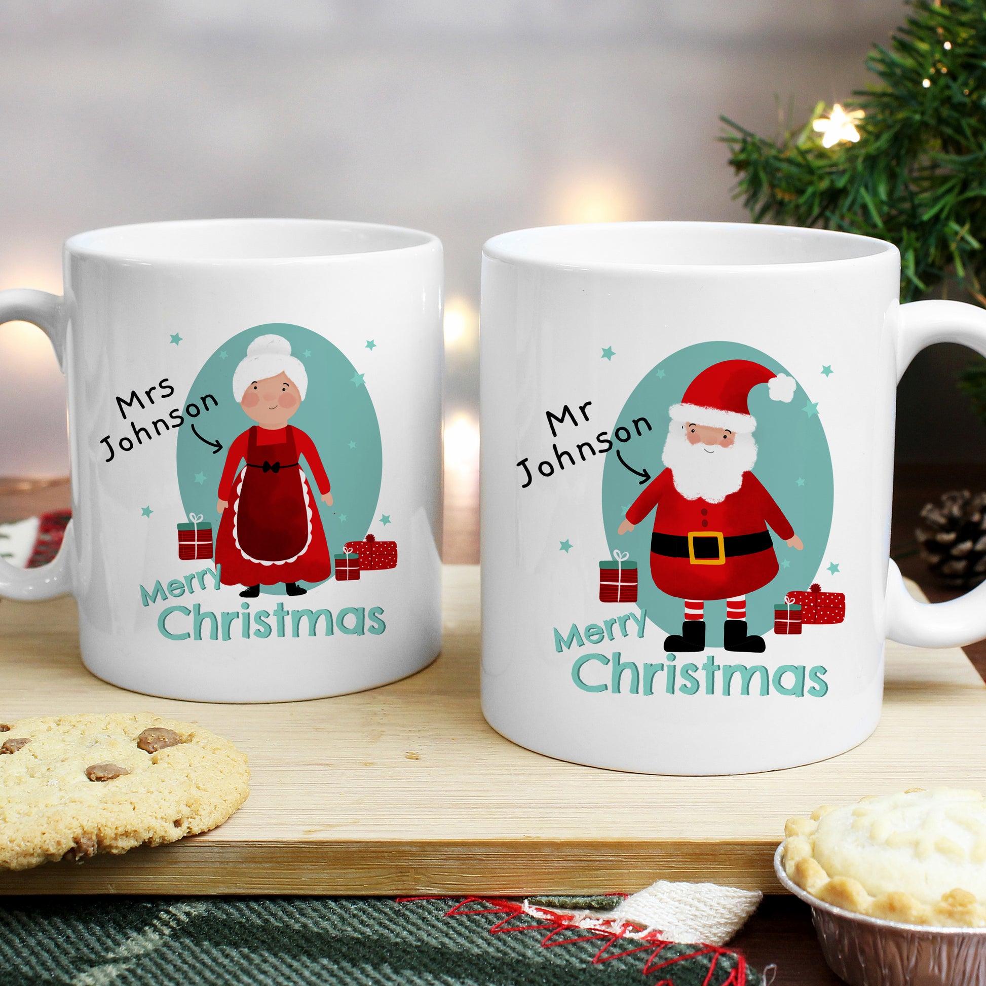 Two Christmas-themed mugs with illustrations of Santa Claus and Mrs. Claus on a festive background.