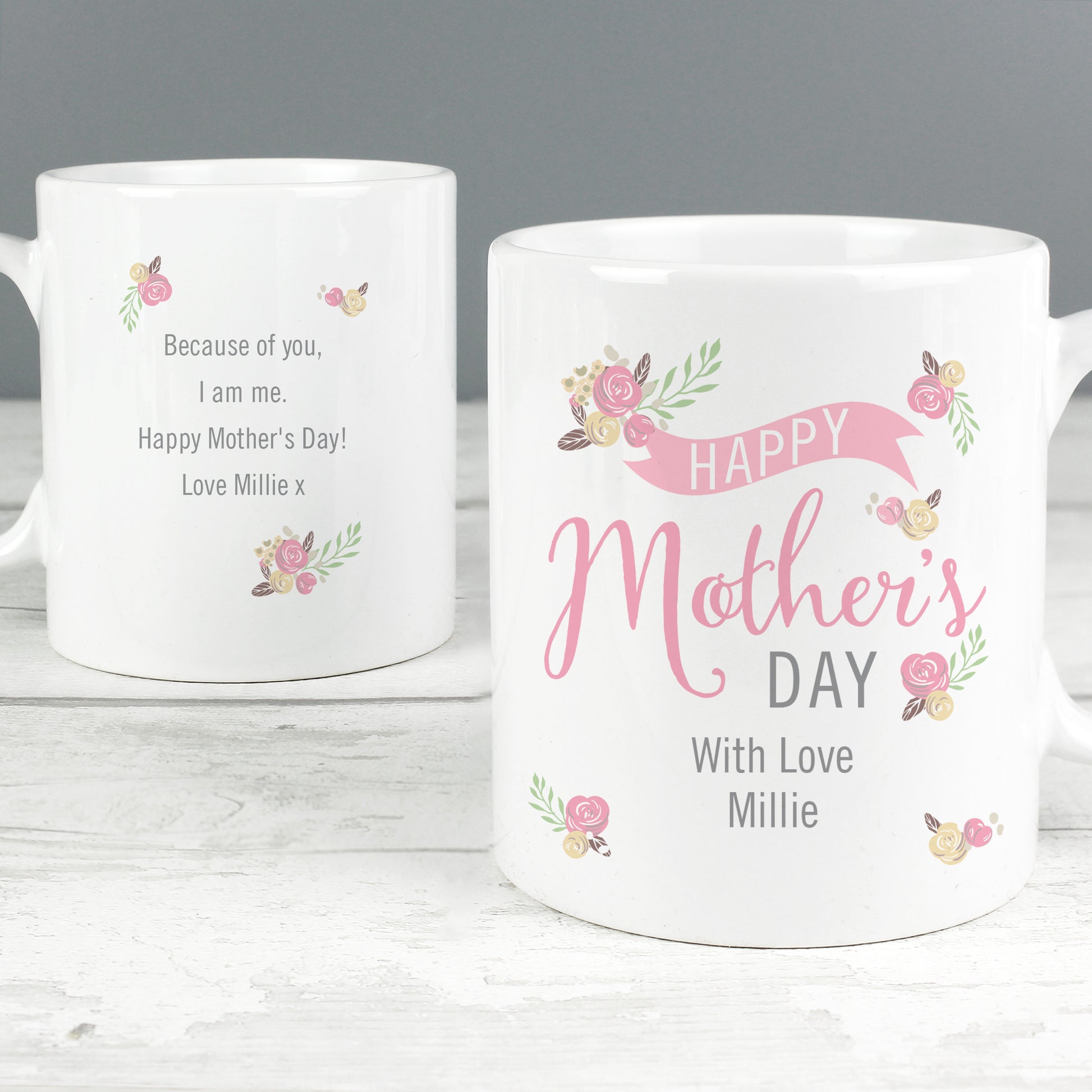 Two Personalised white mugs with Mother's Day messages on a wooden surface.