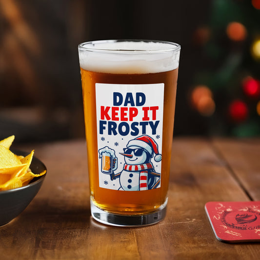 Personalised Beer glass with 'Dad Keep It Frosty' label on a wooden table with chips and a coaster.