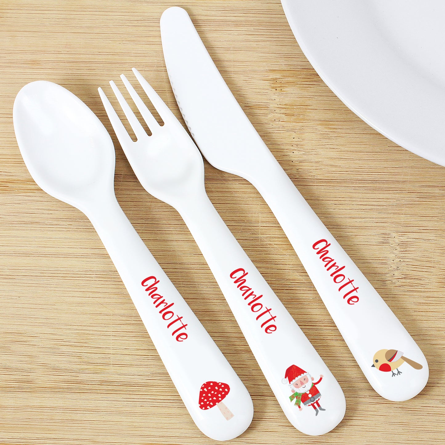 Personalised Children's cutlery set with 'Charlotte' branding on a wooden surface