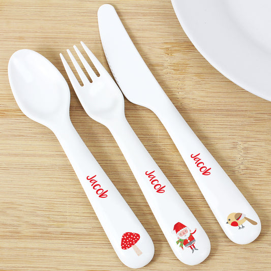 Children's cutlery set with 'Jacob' printed on handles on a wooden surface