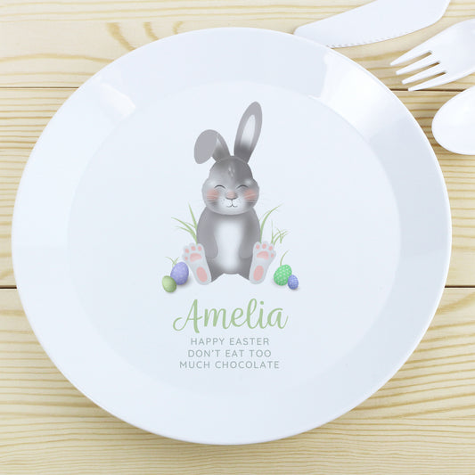 Children's plate with a bunny design and personalised text on a wooden surface