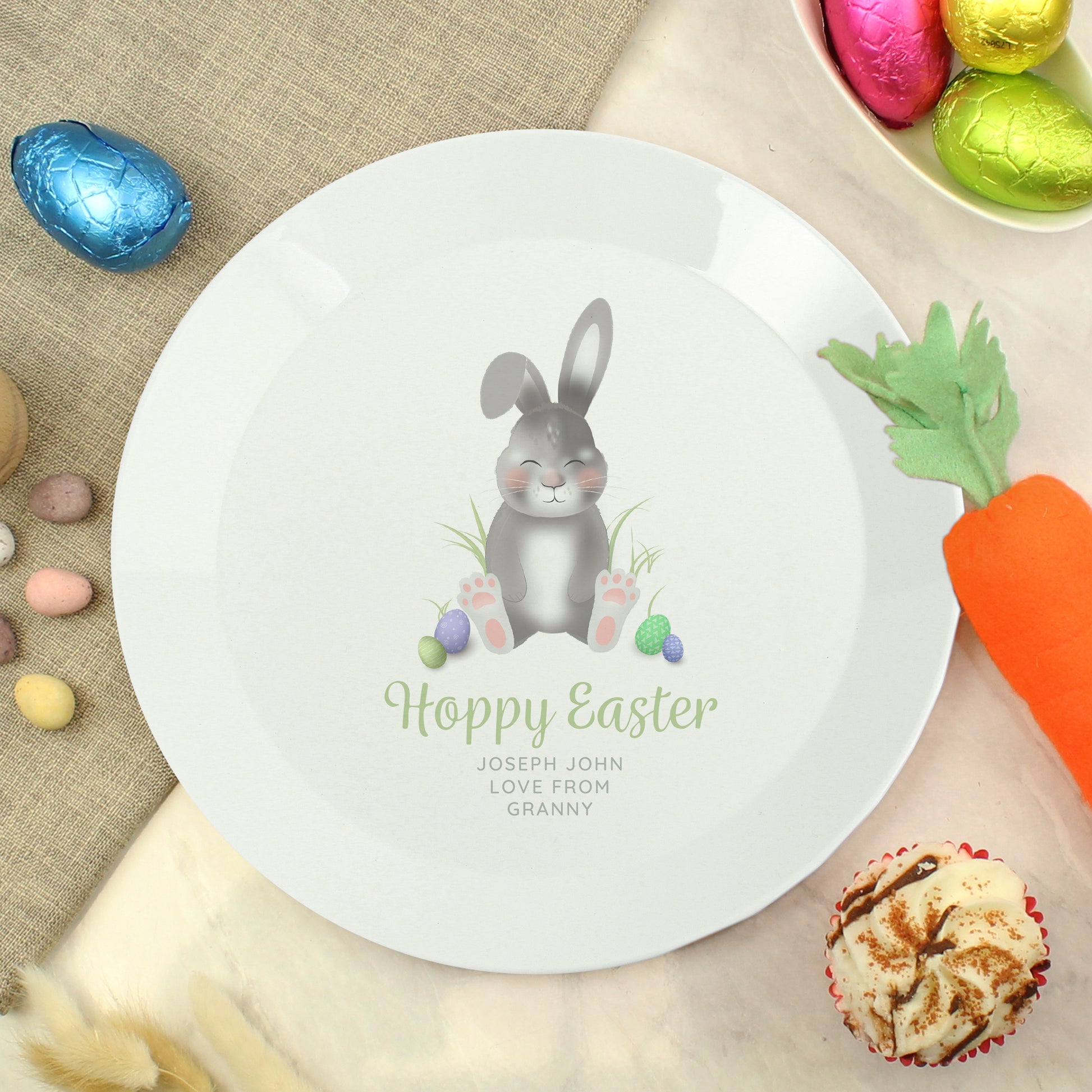 Easter-themed plate with a rabbit illustration and 'Happy Easter' text, surrounded by Easter decorations.