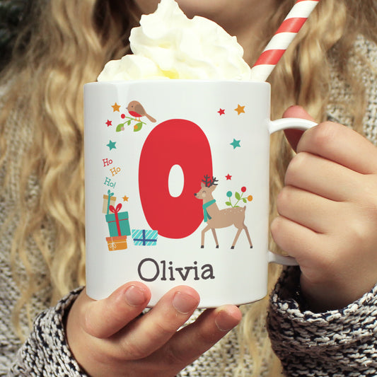 Person holding a personalised mug with 'Olivia' and Christmas-themed design, filled with hot chocolate.