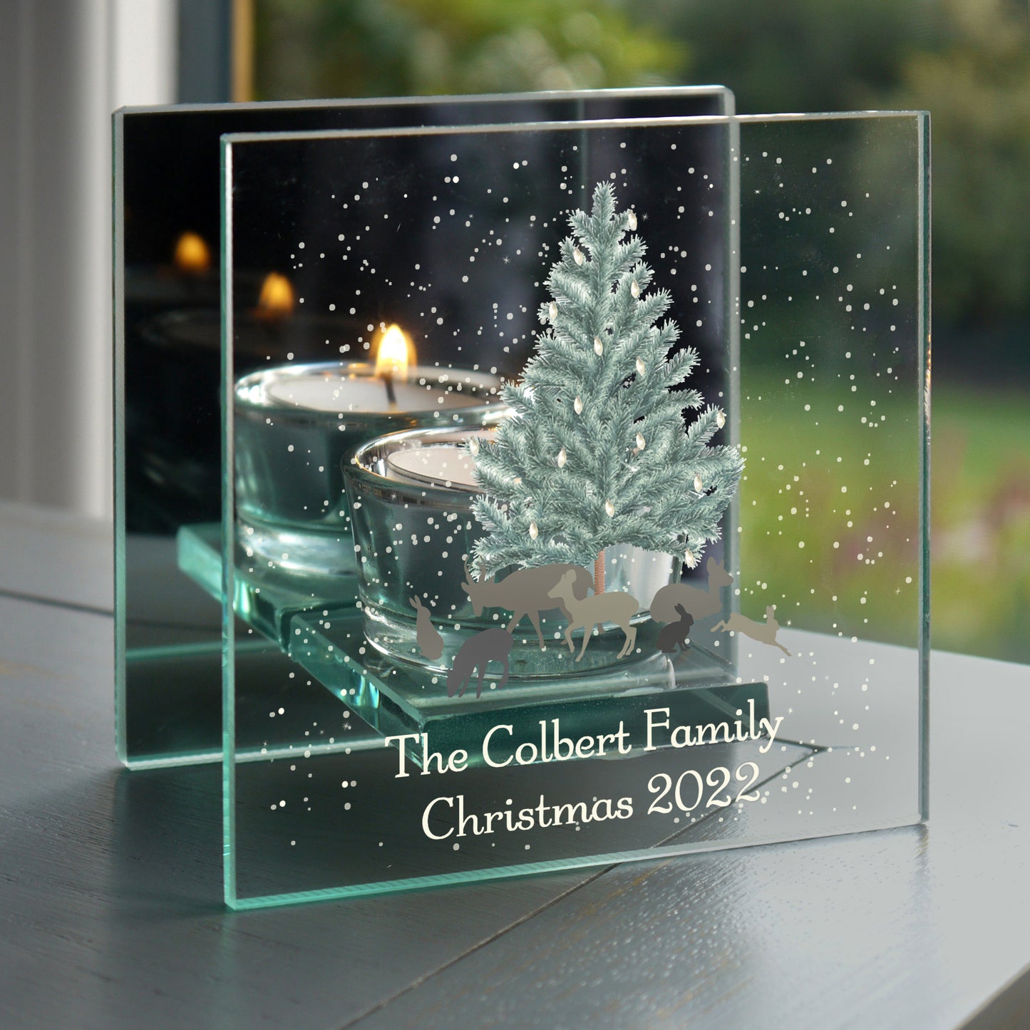 Personalised Christmas decoration with tree, candles, and 'The Colbert Family Christmas 2022' text.