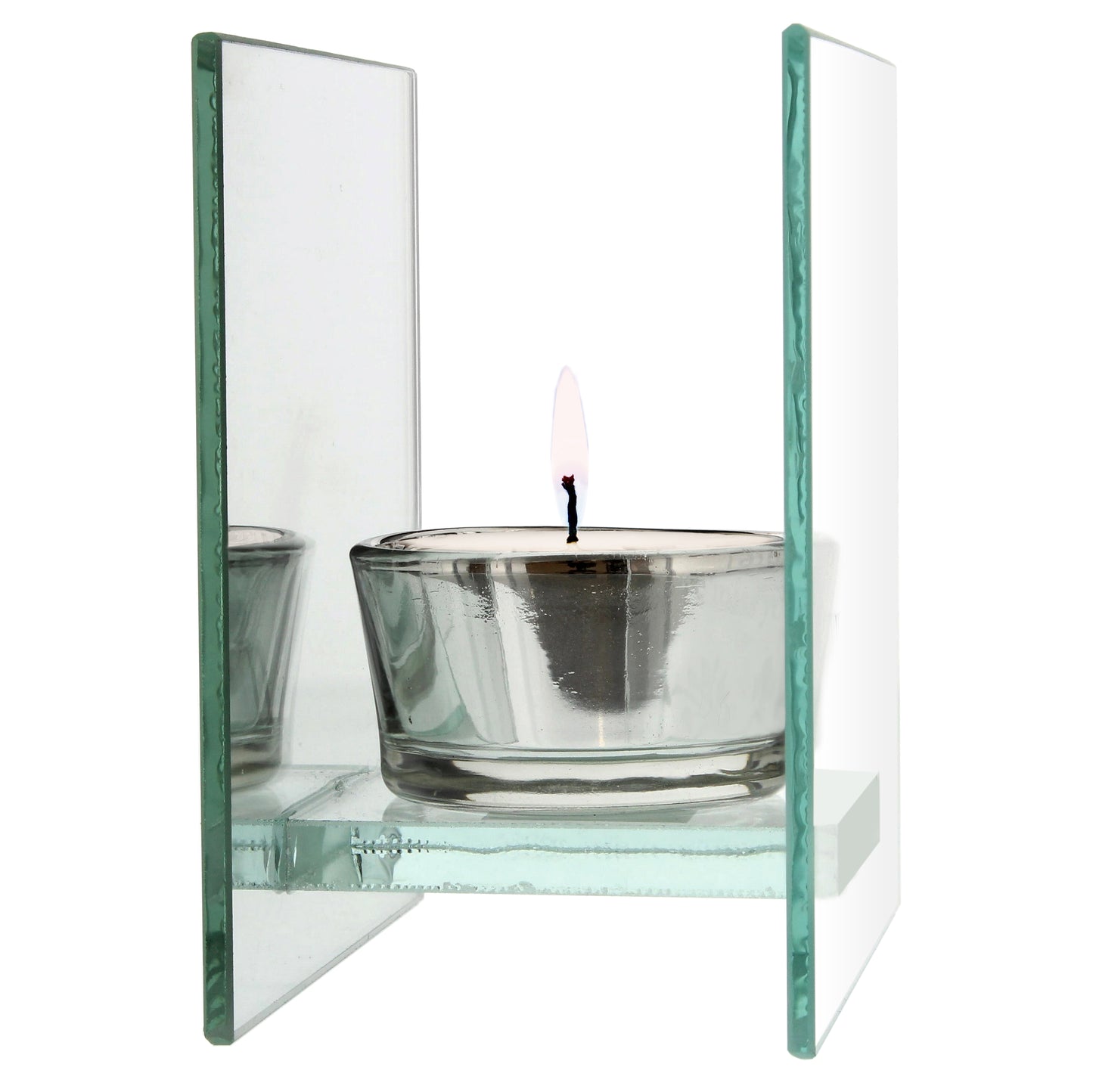 Glass candle holder with a lit candle on a white background
