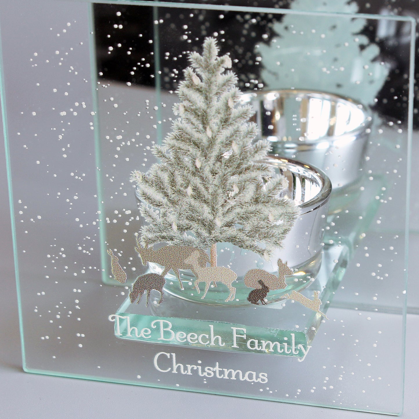 Decorative glass panel with a Christmas scene of a tree and reindeer, engraved with 'The Beech Family Christmas'.