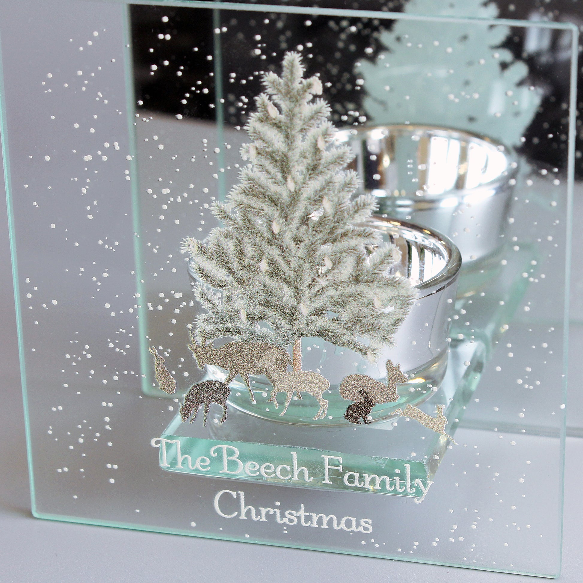 Decorative glass panel with a Christmas scene of a tree and reindeer, engraved with 'The Beech Family Christmas'.
