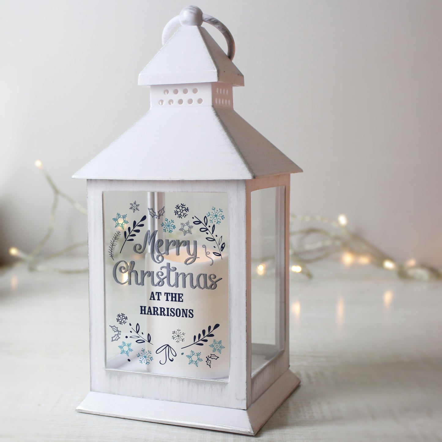 White lantern with 'Merry Christmas at the Harrisons' text on a light background