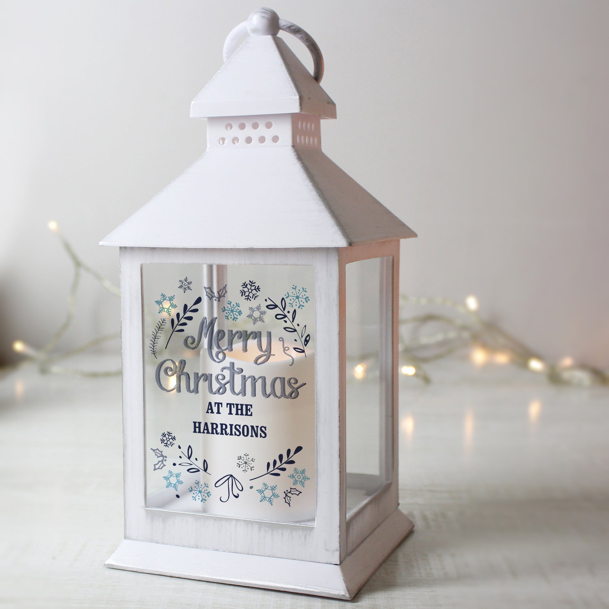 White lantern with 'Merry Christmas at the Harrisons' text on a light background
