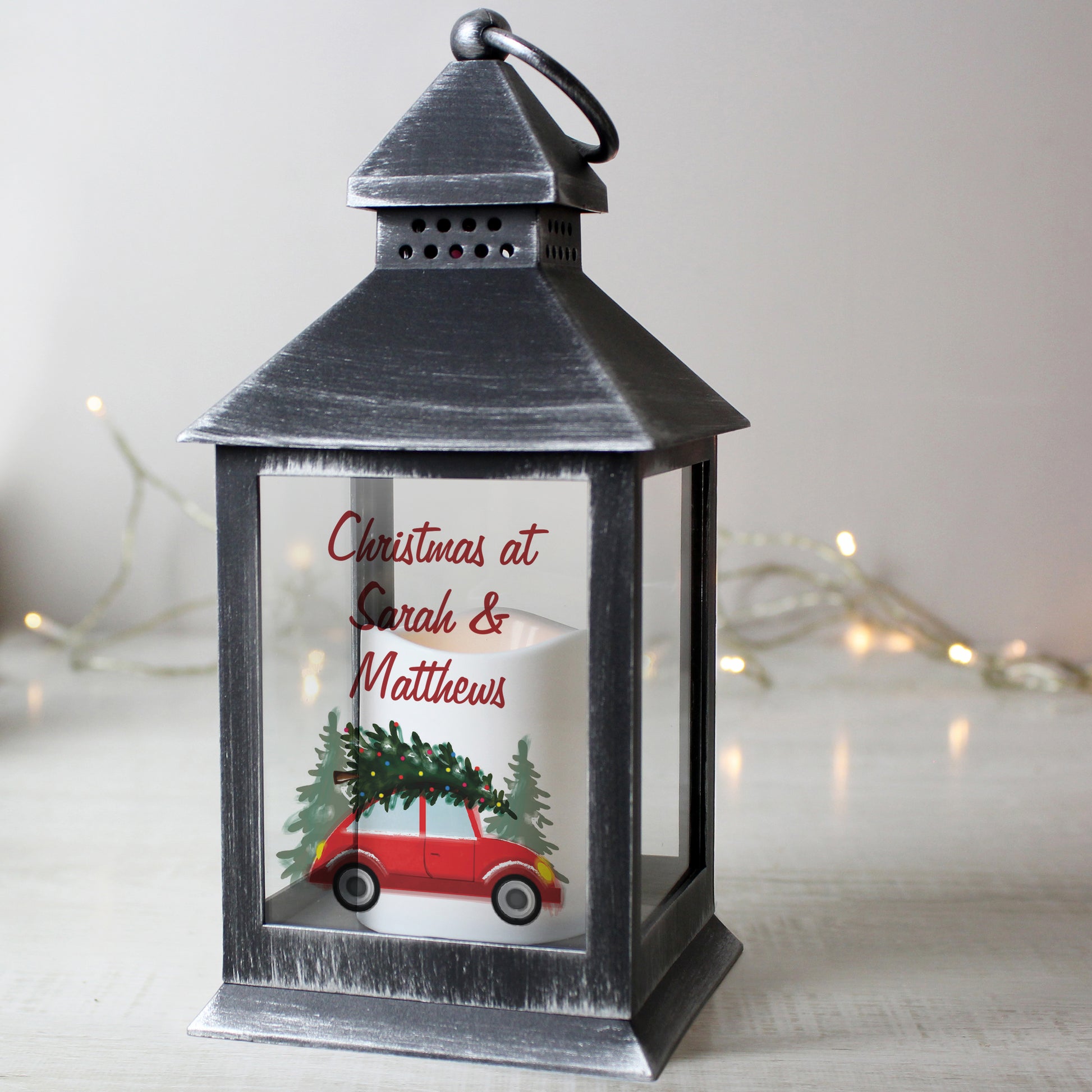 Decorative lantern with Christmas design and text 'Christmas at Sarah & Matthews' on a light background.