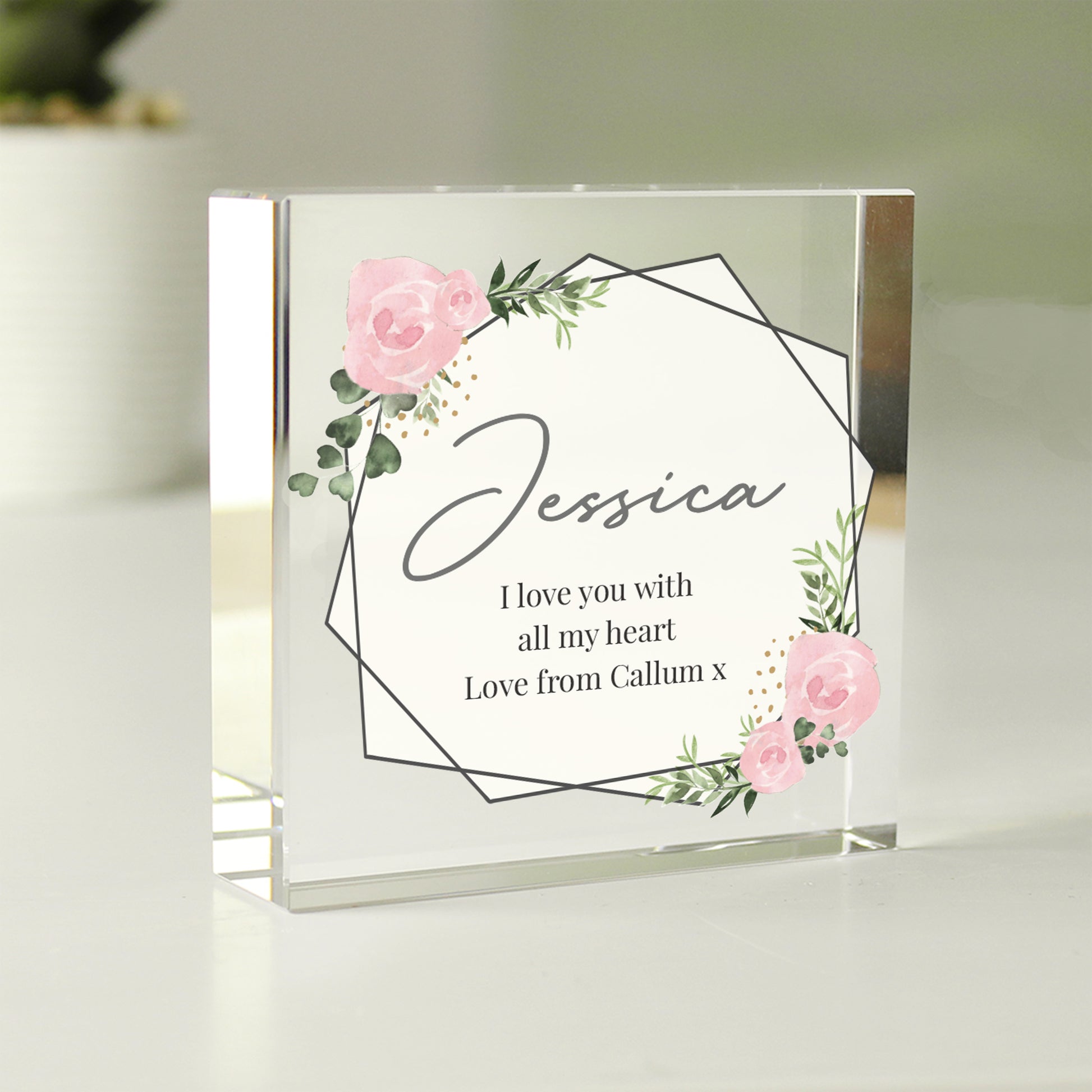 Personalised glass block with floral design and text on a light background
