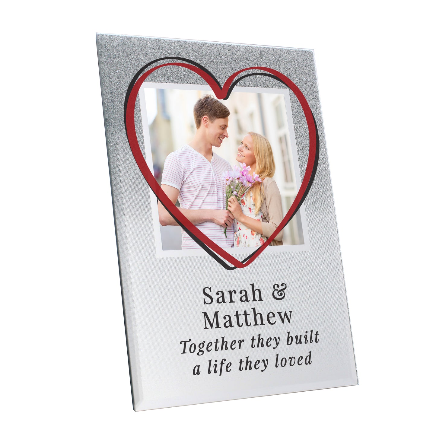 Heart-shaped photo frame with a couple's picture and engraved text on a white background