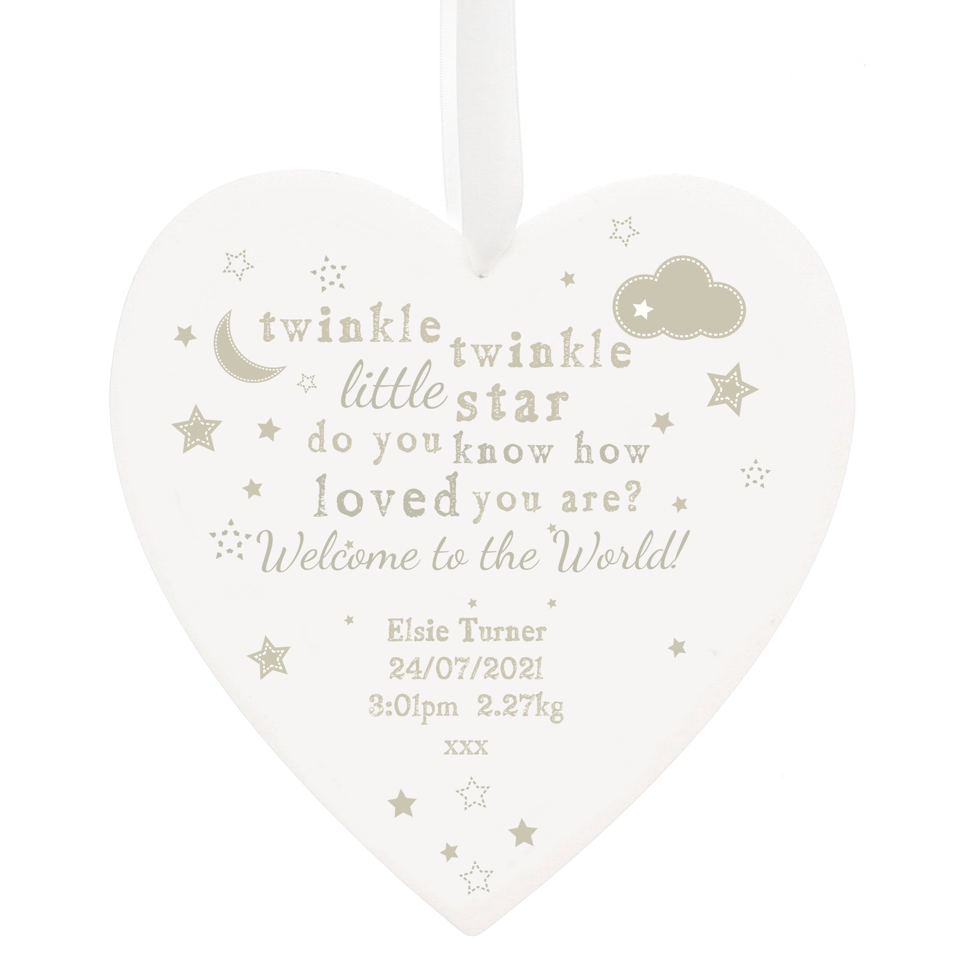 Heart-shaped decorative plaque with baby milestone text on a white background