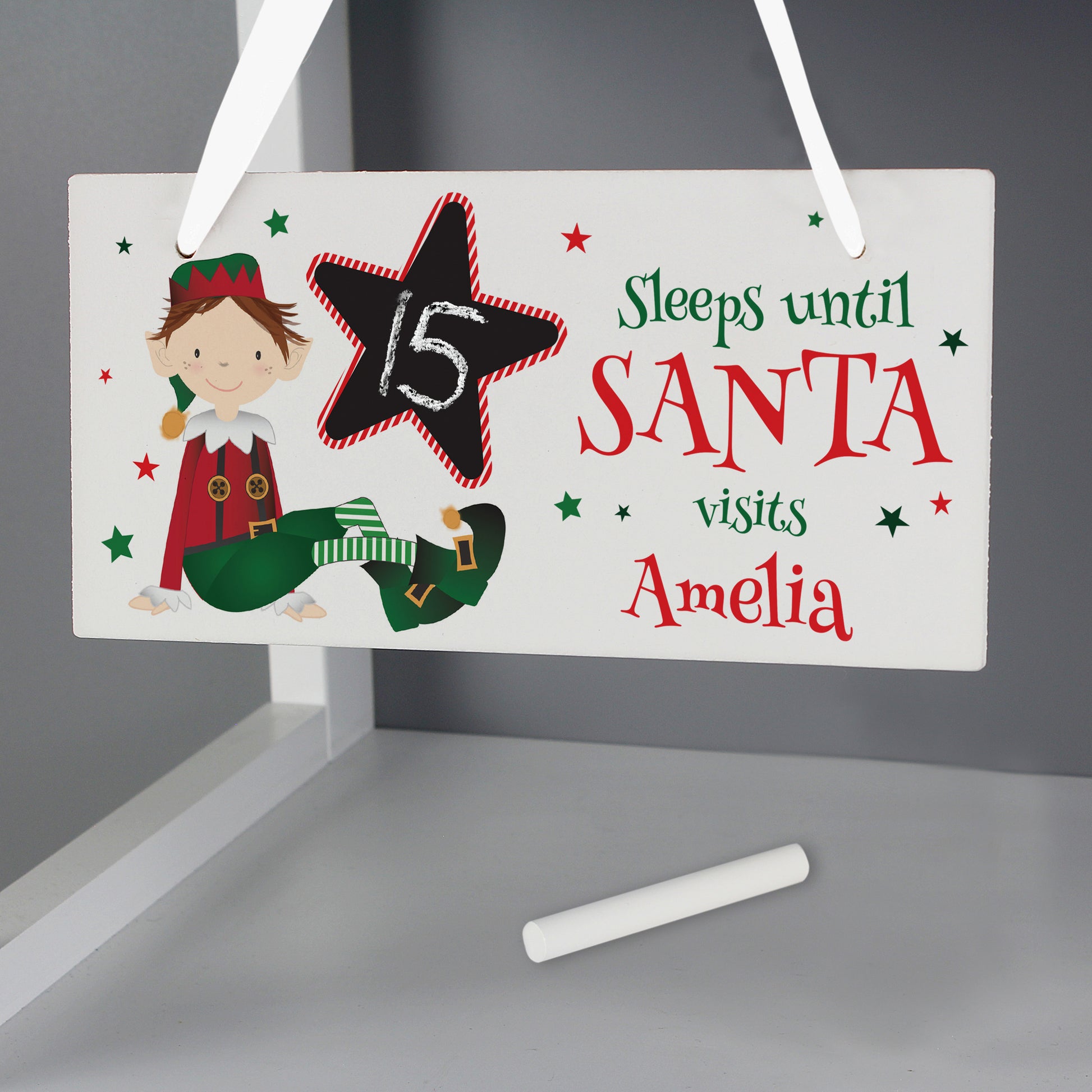 Christmas countdown sign with elf illustration and chalk for writing, on a gray background