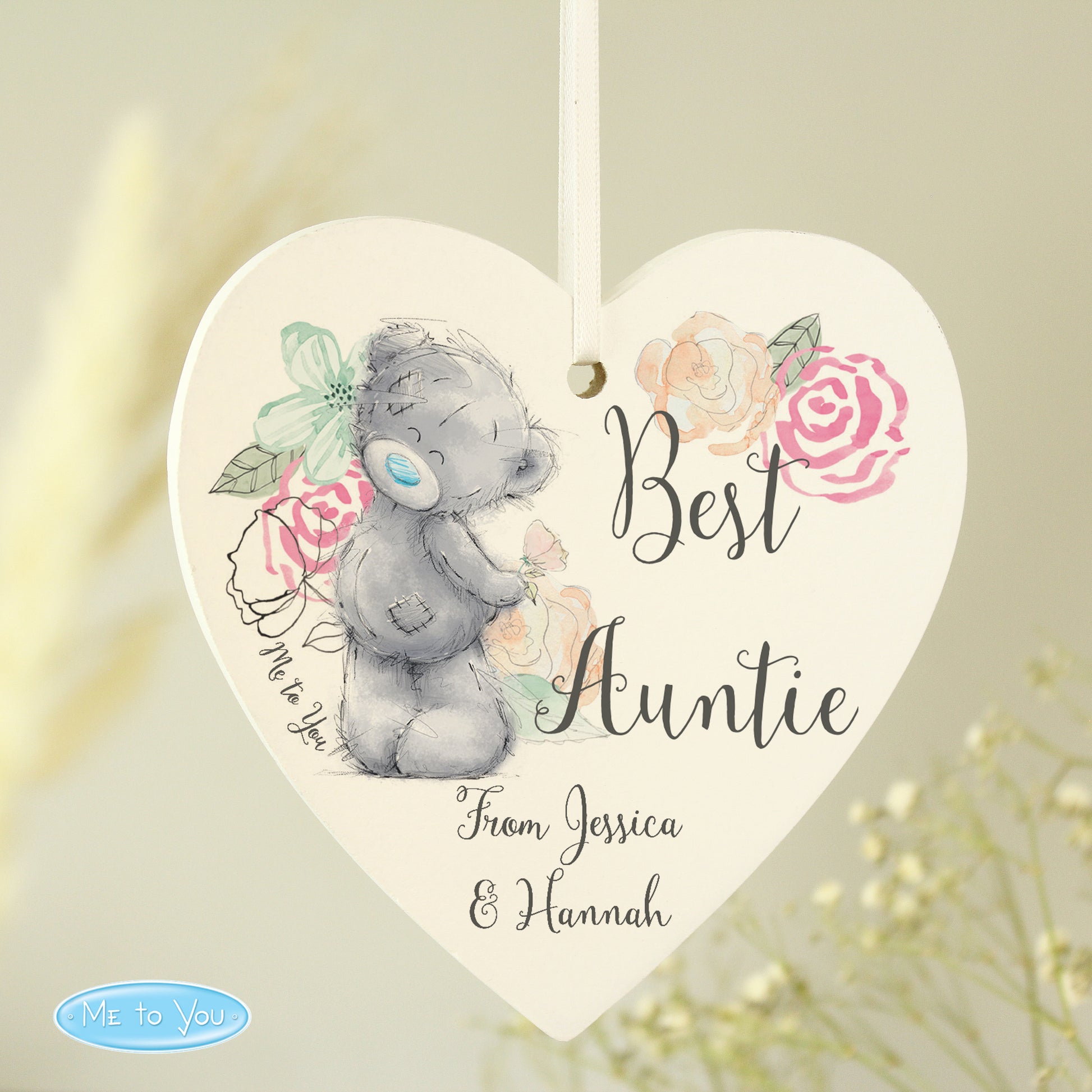Heart-shaped decorative plaque with a teddy bear and floral design, featuring the text 'Best Auntie From Jessica & Hannah'.