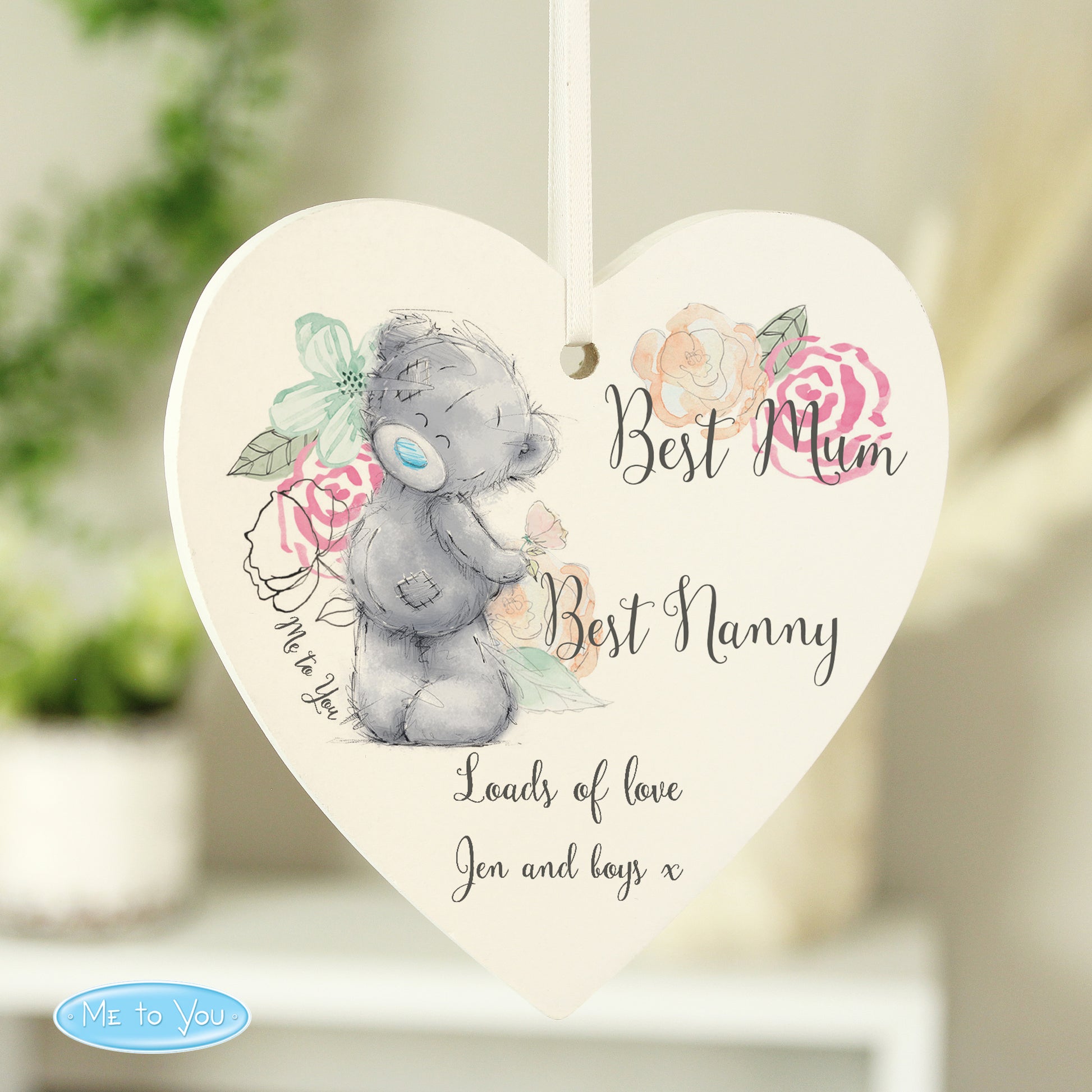 Heart-shaped hanging plaque with a teddy bear design and floral elements, featuring text 'Best Mum Best Nanny Loads of love Jen and boys x'.