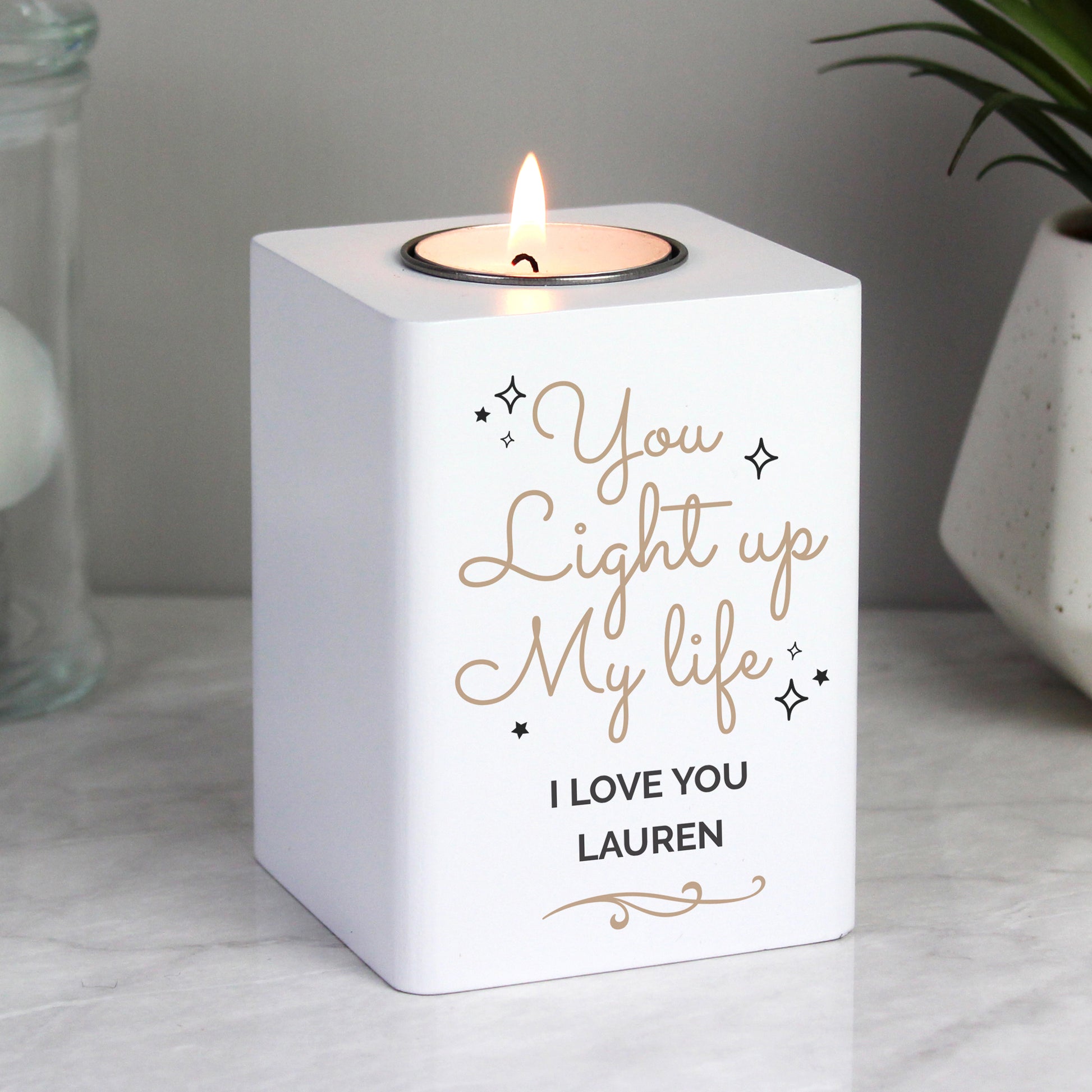 Personalised White candle holder with 'You light up my life, I love you Lauren' text, lit candle inside.