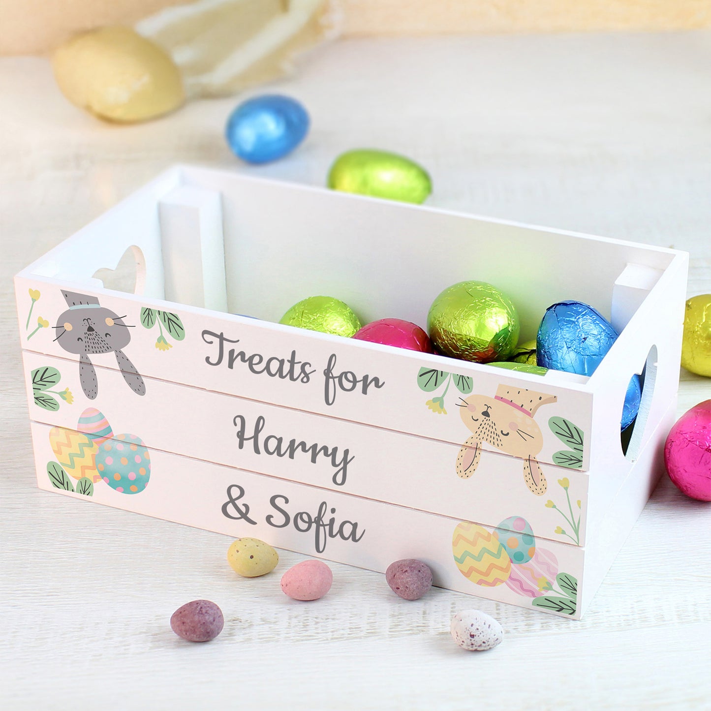 Easter basket with colorful eggs and personalized text on a light background
