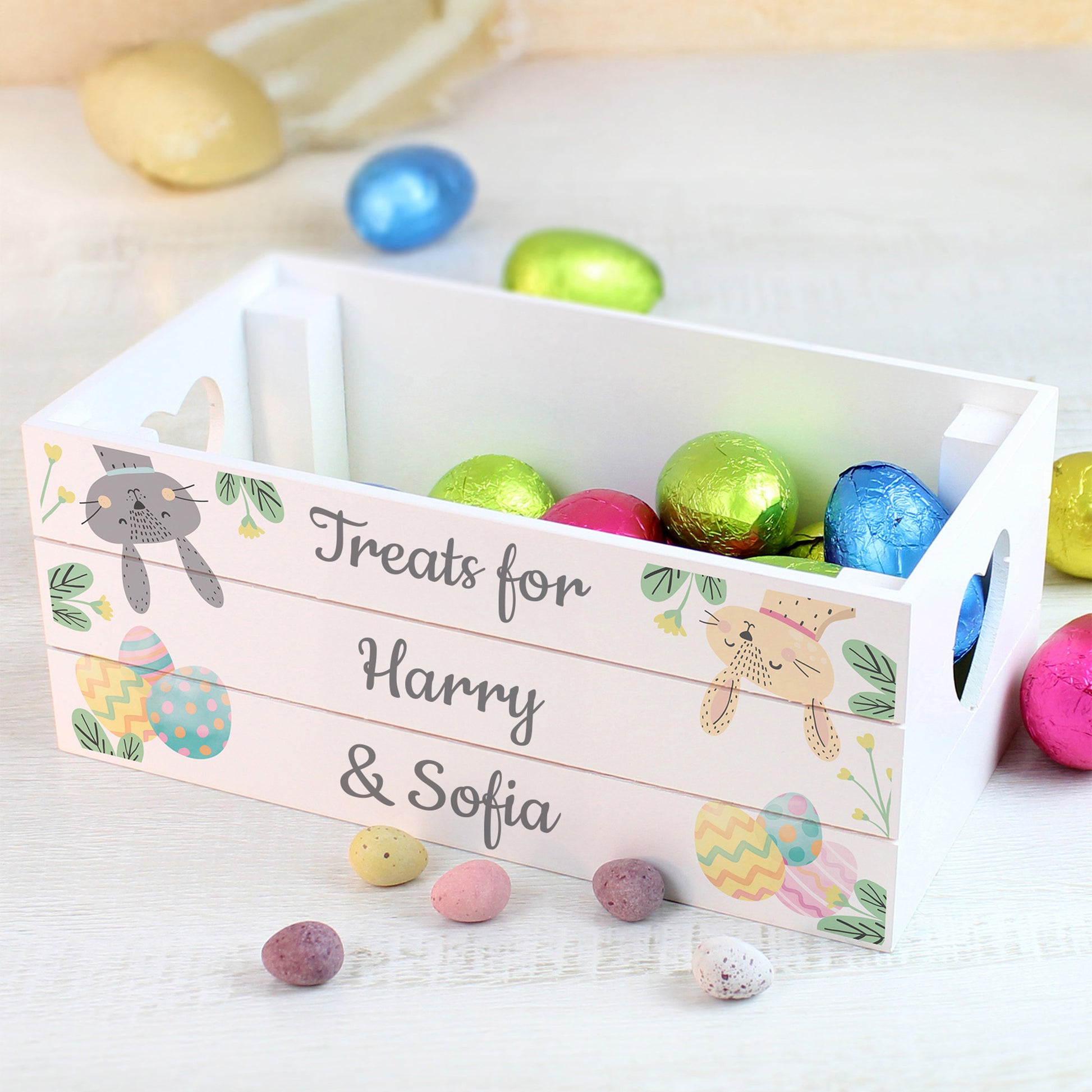 Easter basket with colorful eggs and personalized text on a light background