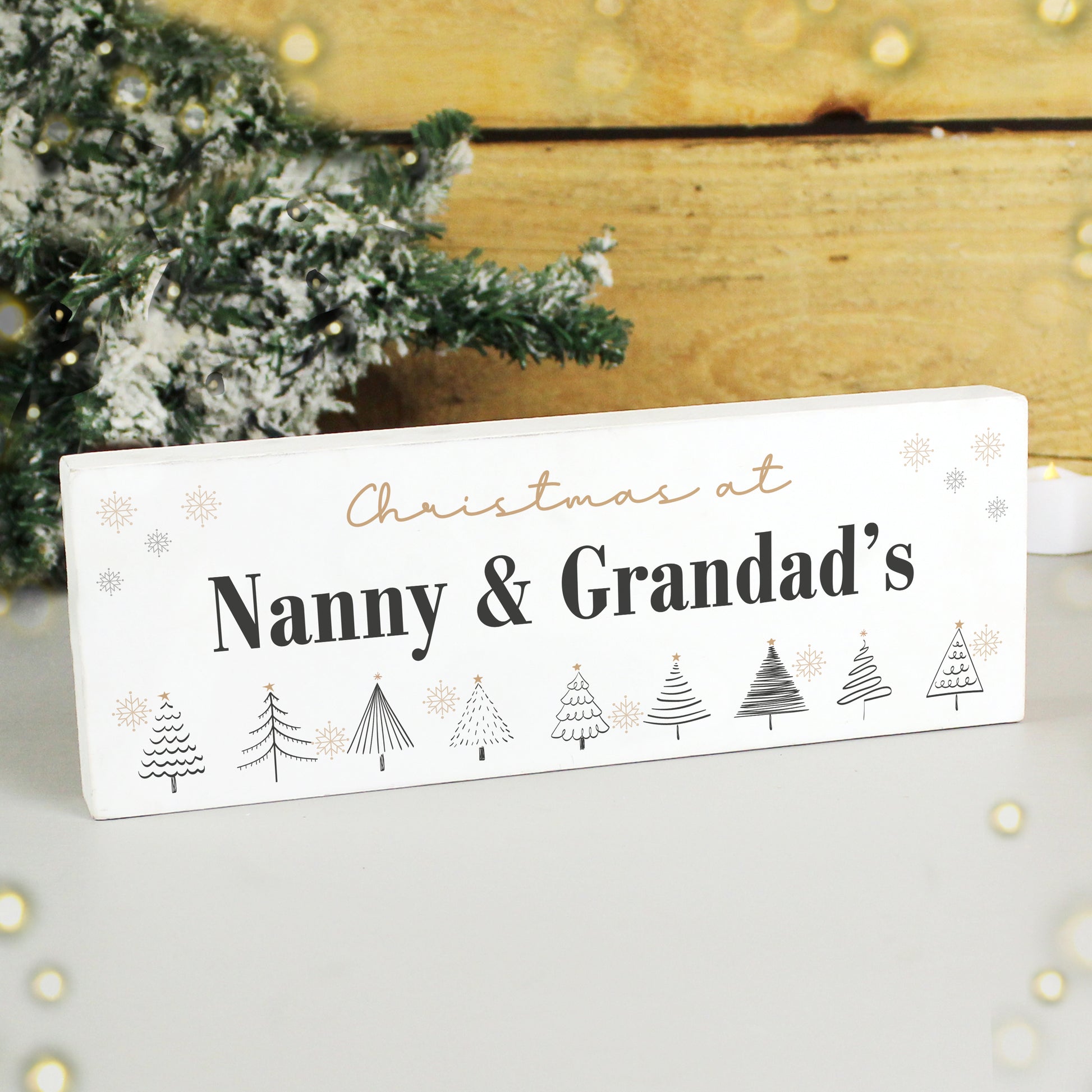 Decorative sign with 'Christmas at Nanny & Grandad's' text and Christmas tree illustrations on a white background.