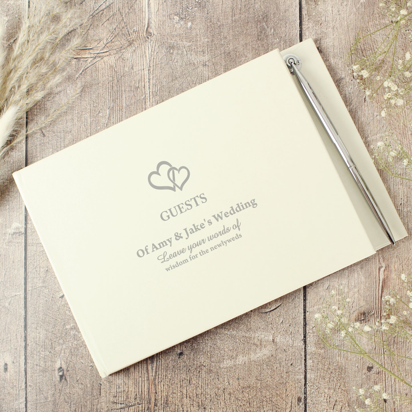 Wedding guest book with pen on a wooden surface