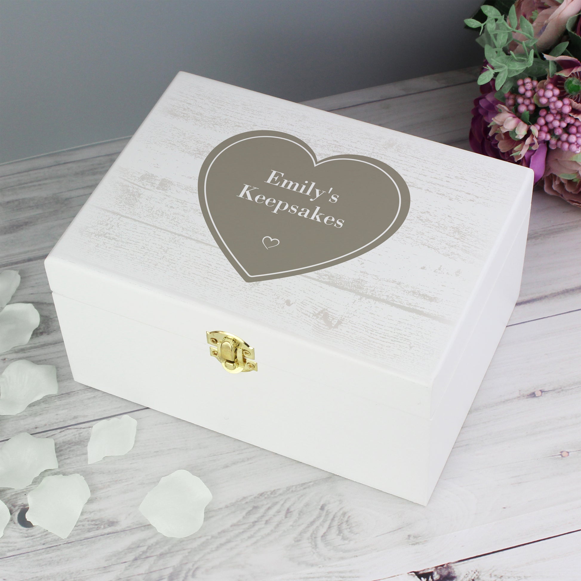 White keepsake box with 'Emily's Keepsakes' engraving on a wooden surface.