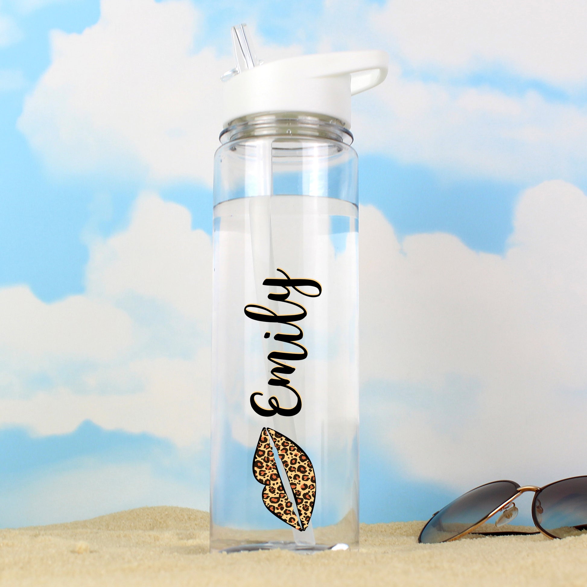 Clear water bottle with 'Emily' and a leopard print design on a beach background