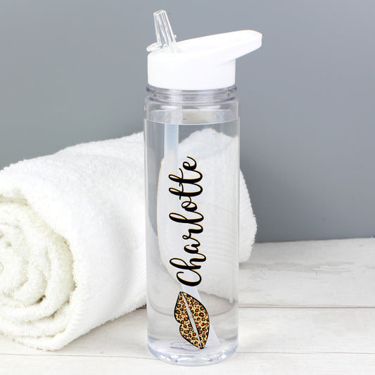 Personalised Clear water bottle with 'Charlotte' and a leopard print design on a white surface with a grey background