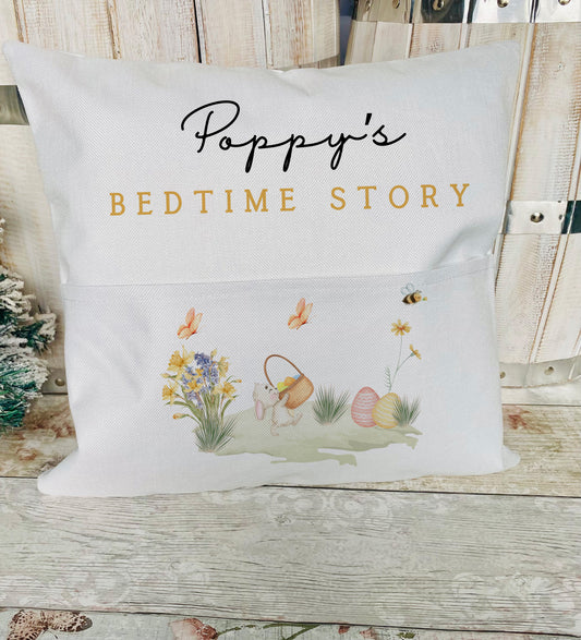 Personalised bedtime story cushion with pocket, featuring Easter-themed design with bunny, basket, flowers, and custom name text