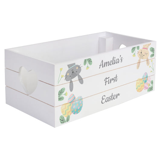 White wooden crate with Easter-themed decorations and 'Amelia's First Easter' text on a white background
