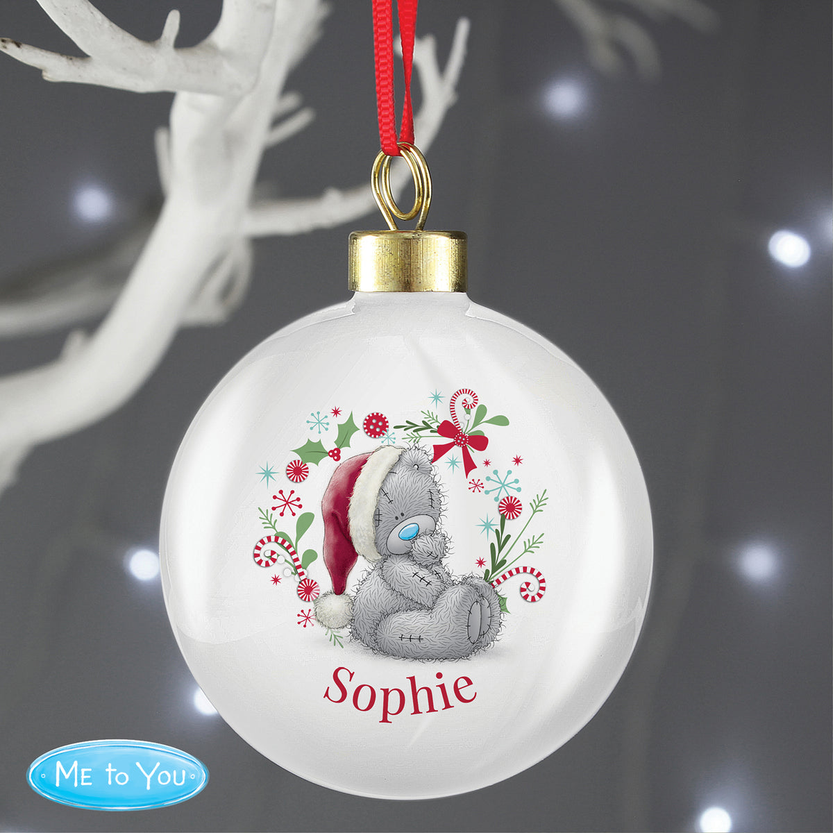 Christmas ornament with a teddy bear wearing a Santa hat and the name 'Sophie'.
