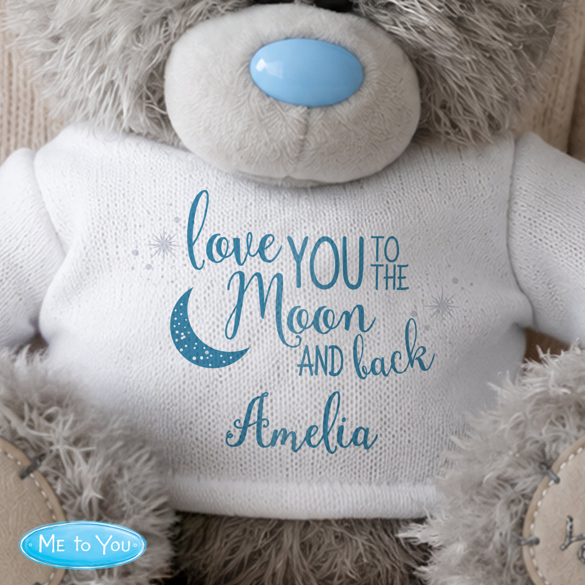 Personalised Teddy bear with 'love you to the moon and back Amelia' text on a white background