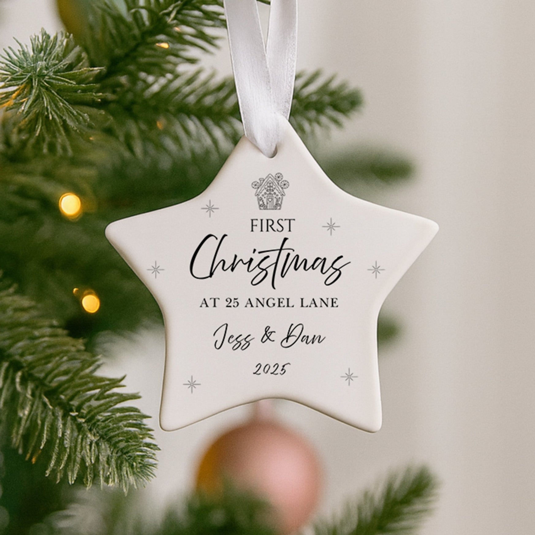 Star-shaped ornament on a Christmas tree with personalized text