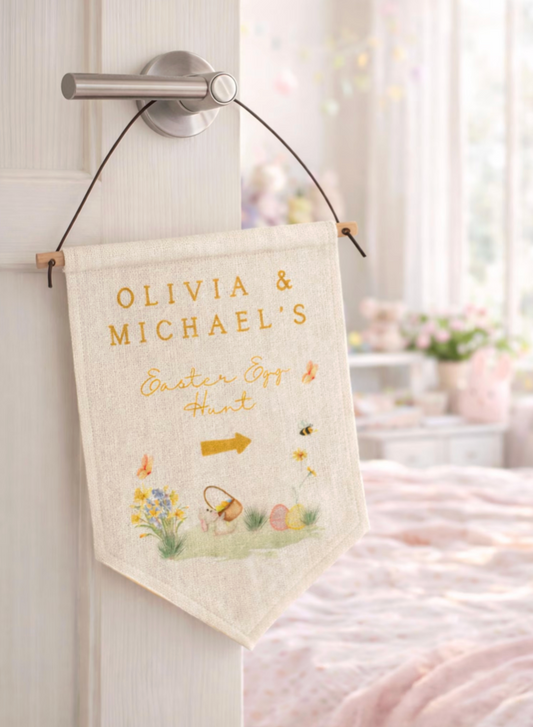 Personalized Easter banner with 'Olivia & Michael's Easter Egg Hunt' text hanging on a door.