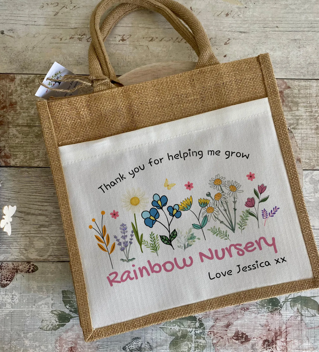 Jute bag with Thank You For Helping Me Grown message against a wooden wall background