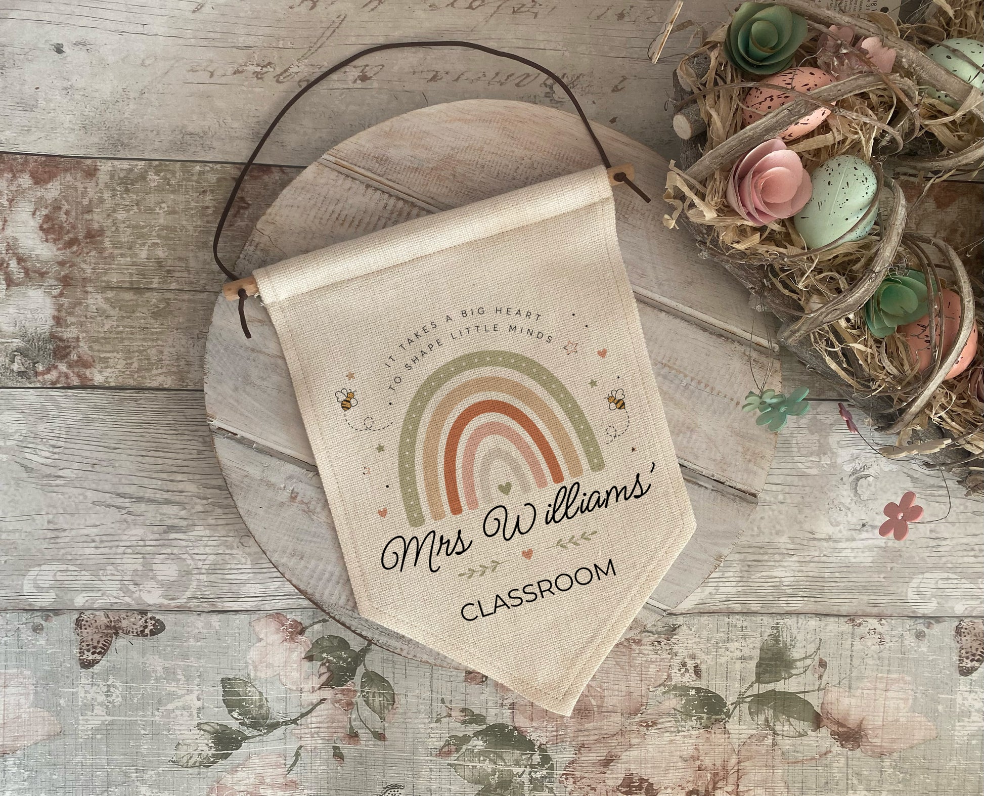 Personalised Teacher classroom sign with rainbow and Bee design and text on a wooden surface