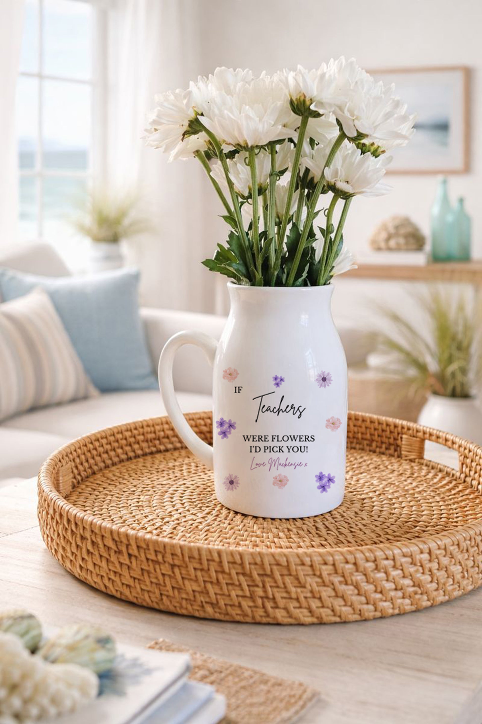 Vase with flowers on a woven tray in a living room setting