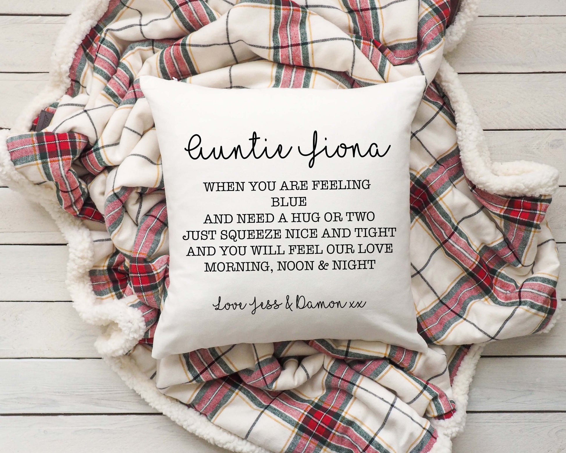 Personalised Linen Cushion with text on a plaid blanket